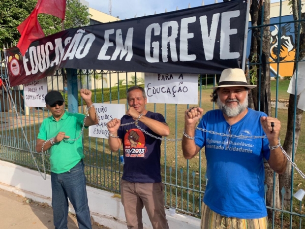 Em greve h quase 60 dias, servidores da educao se acorrentam no porto do Palcio Paiagus