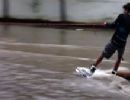 Jovem pratica wakeboard nas ondas da enchente em Vitria, ES